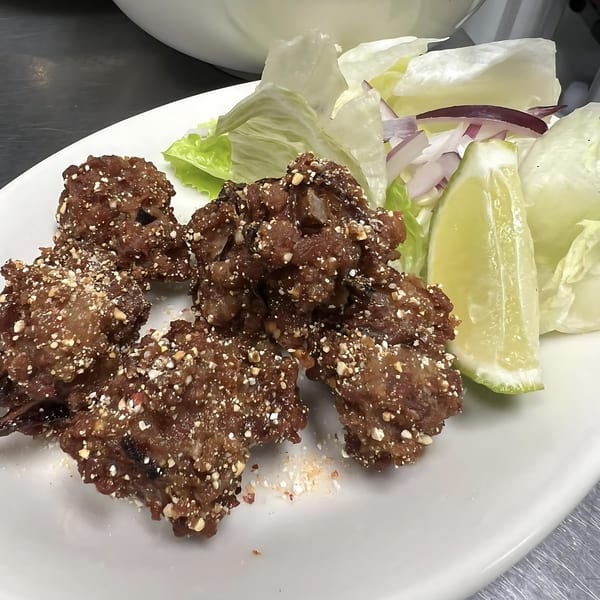Thai Bistro & Bar's crispy fried rice balls with lettuce, red onion, and lime.