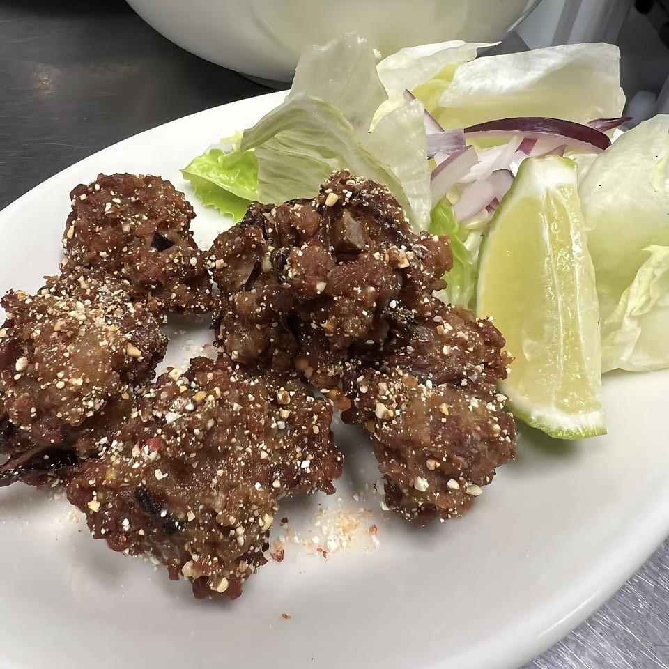 Thai Bistro & Bar's crispy fried rice balls with lettuce, red onion, and lime.